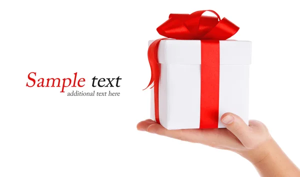 Gift with red bow in hand — Stock Photo, Image