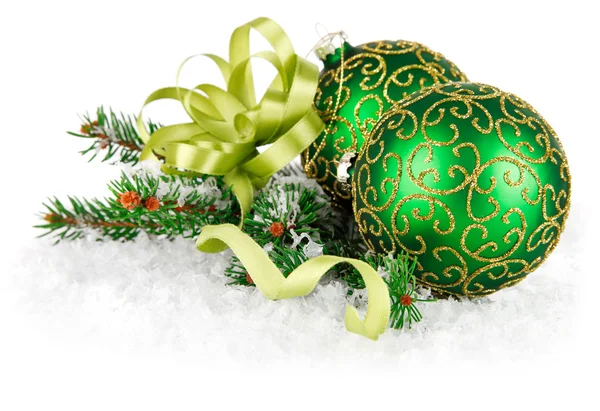 Green balls in snow with gold bow — Stock Photo, Image
