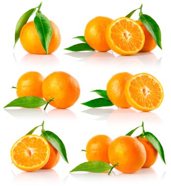 Set of fresh mandarine fruits with cut and green leaves clipart