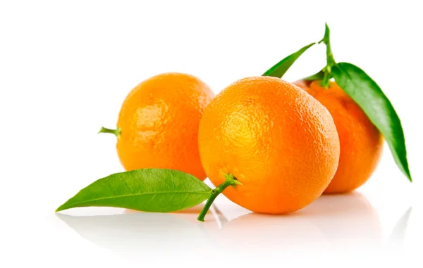 Taze mandarine meyveler yeşil ile izole bırakır — Stok fotoğraf