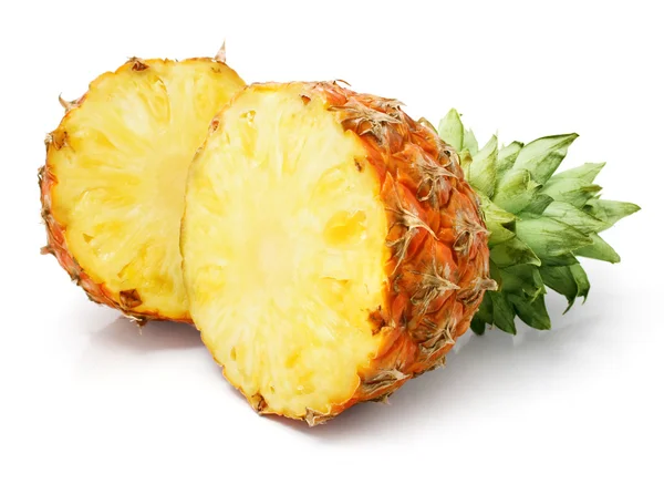 Fresh pineapple fruit with cut and green leaves — Stock Photo, Image