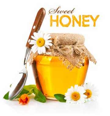 Sweet honey in glass jar with spoon and flowers clipart