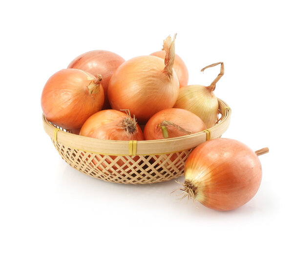 Onion fruits in the basket isolated on white