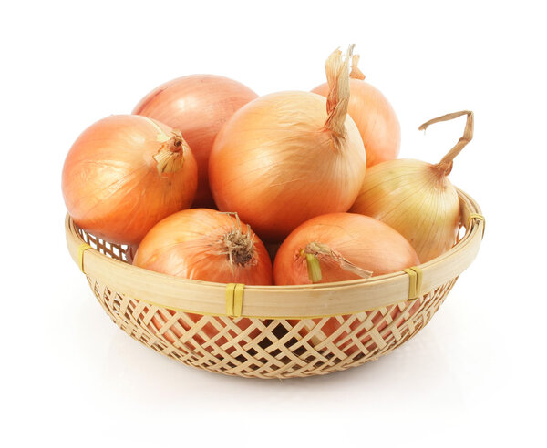 Onion fruits in the basket isolated on white