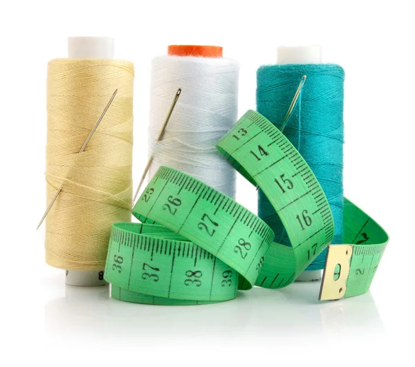 Color threads with needles and green measuring line — Stock Photo, Image