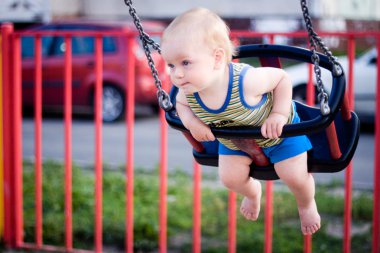 Baby in a swing clipart