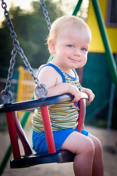 Baby in a swing — Stock Photo, Image