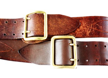 Old leather belts on white clipart