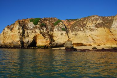 Yellow cliffs in Lagos in the Algarve Portugal clipart