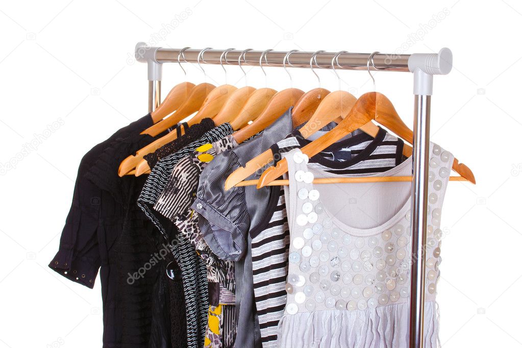 Different clothes on hangers isolated on white
