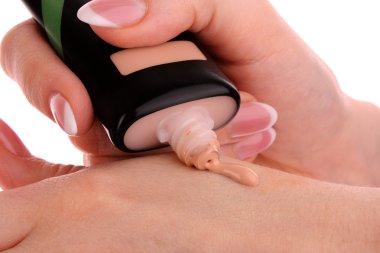 Tone cream in the woman's hand clipart