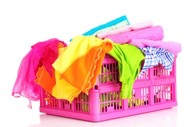 Bright clothes in a laundry basket on white background clipart