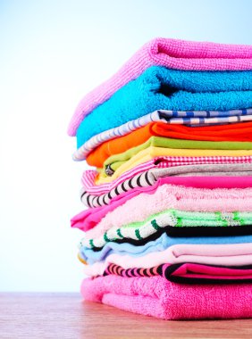 Pile of colorful clothes over blue background clipart