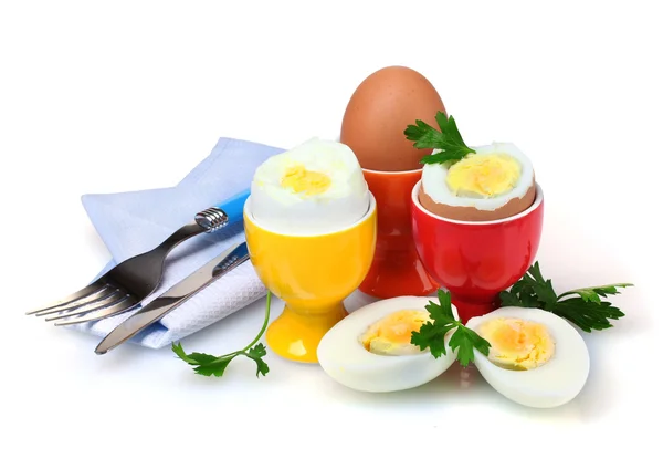 Boiled eggs in bright stands and cutlery — Stock Photo, Image