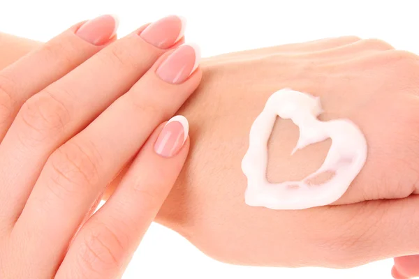 Two woman hands spreading the cream in the form oh heart isolate — Stock Photo, Image