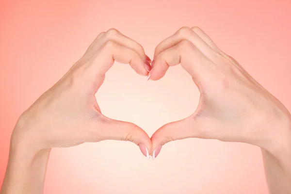 Hands making heart on red background — Stock Photo, Image