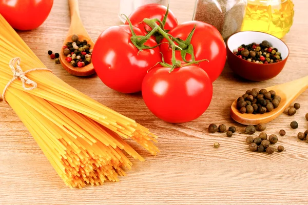Spaghetti di pasta con pomodori, olio d'oliva, pepe e basilico su una — Foto Stock