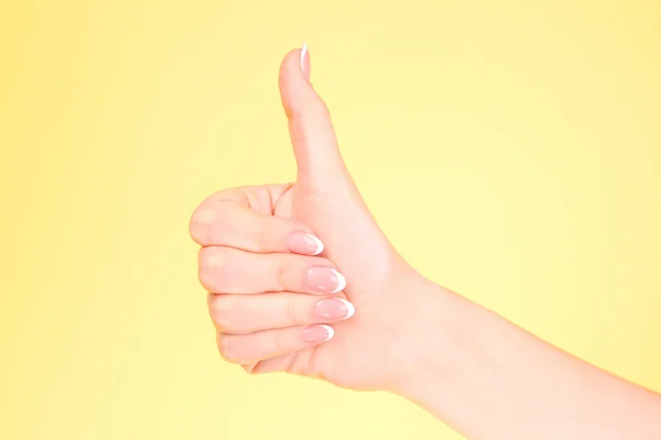 Gestures of hands - OK, on yellow background — Stock Photo, Image