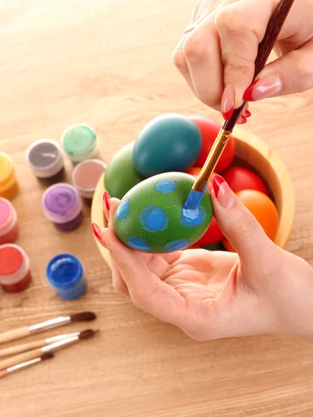 Ręce trzymać Wielkanoc jaja, kolor farby i Pędzel — Zdjęcie stockowe