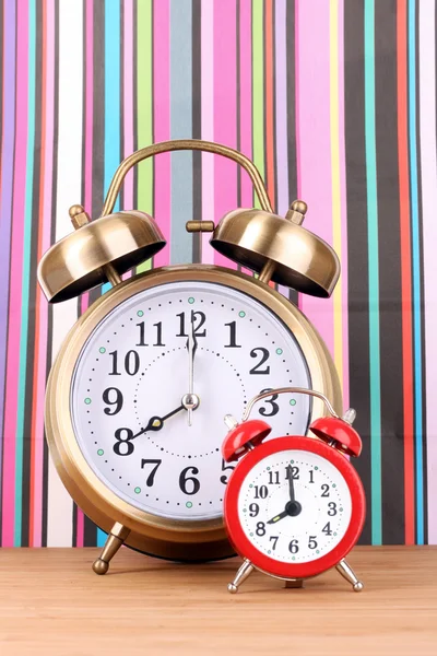 Two clocks on color background — Stock Photo, Image