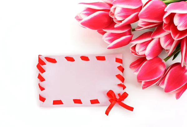 Bouquet of tulips and post card on white — Stock Photo, Image
