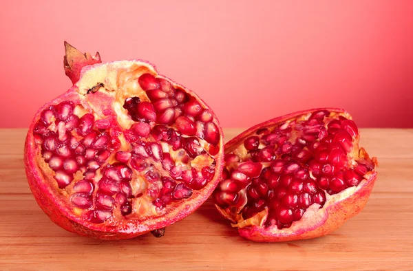 Pomegranate isolated on wooden table — Stock Photo, Image