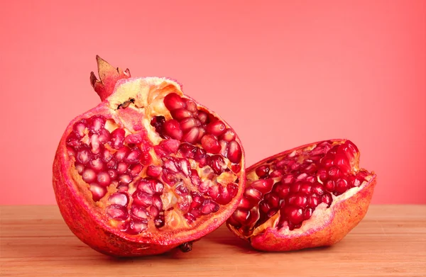 Pomegranate isolated on wooden table — Stock Photo, Image