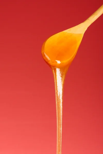 Wooden spoon with honey — Stock Photo, Image