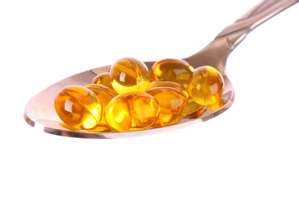 A spoon full of Fish Oil Capsules isolated on white — Stock Photo, Image