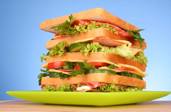 Huge sandwich on blue background — Stock Photo, Image