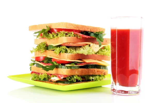 Huge sandwich and glass of tomato juice on white background — Stock Photo, Image