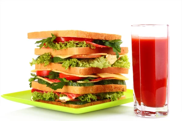 Huge sandwich and glass of tomato juice on white background — Stock Photo, Image