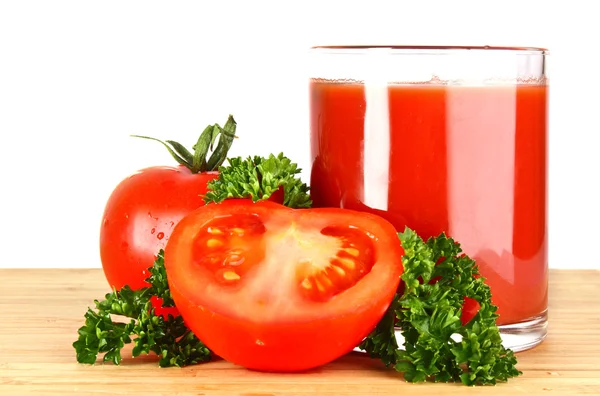 Glass of fresh tomato juice and tomatoes round the glass on th — Stock Photo, Image