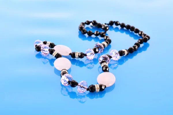 Beads on blue background — Stock Photo, Image