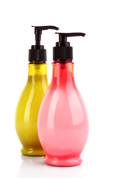 Růžové andgreen mýdlo láhve na bílém pozadí — Stock fotografie