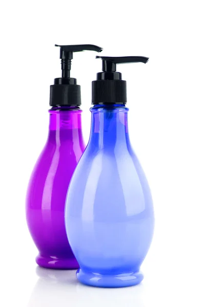 Beyaz üzerine pembe ve mavi sabun şişeler — Stok fotoğraf