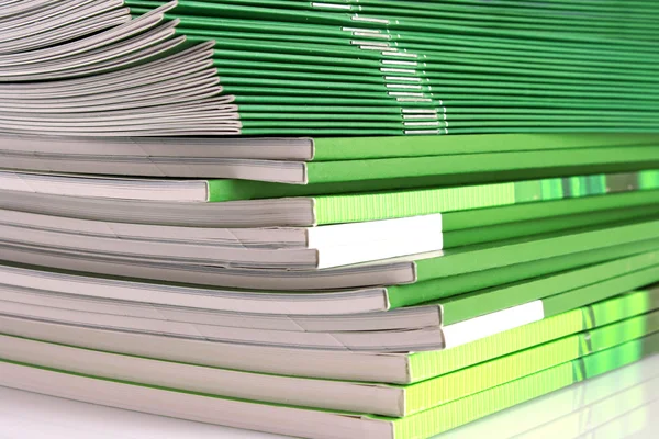 Pile of green magazines isolated on white background — Stock Photo, Image