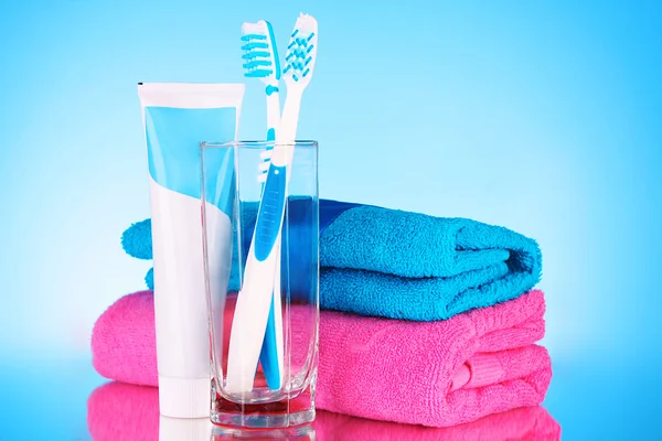 Tooth-paste and brush on blue background — Stock Photo, Image