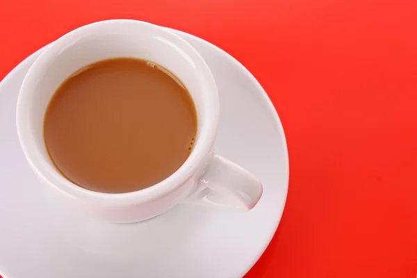 Piccola tazza bianca con caffè su sfondo rosso — Foto Stock