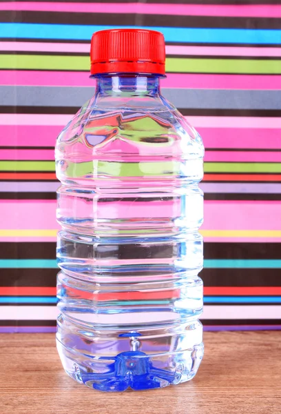 Bottle of water on color background — Stock Photo, Image