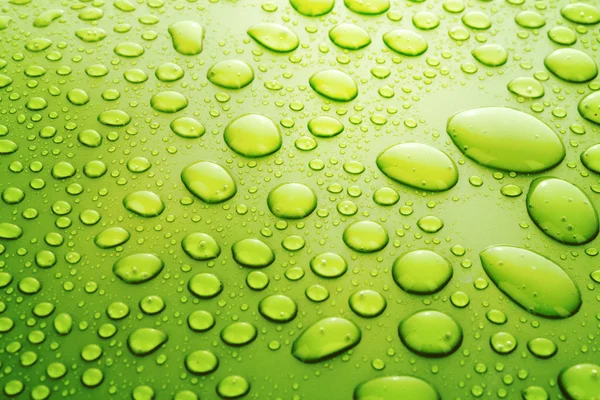 Gula vatten droppar bakgrund med stora och små droppar — Stockfoto