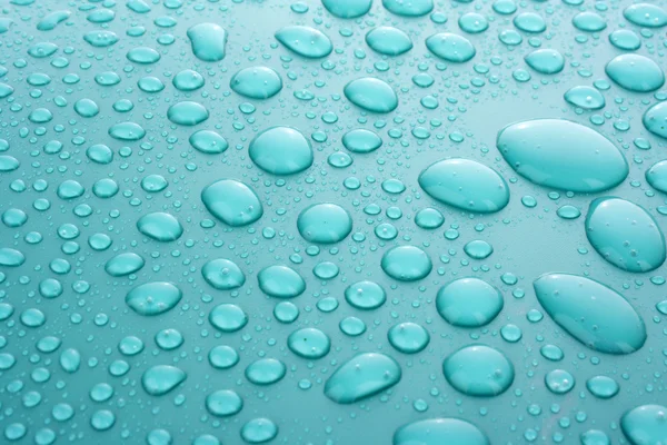 Gotas de agua azul de fondo con grandes y pequeñas gotas —  Fotos de Stock