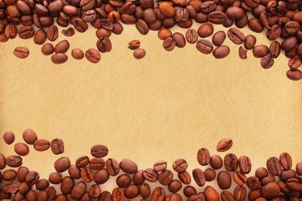 Coffee beans on old paper background — Stock Photo, Image
