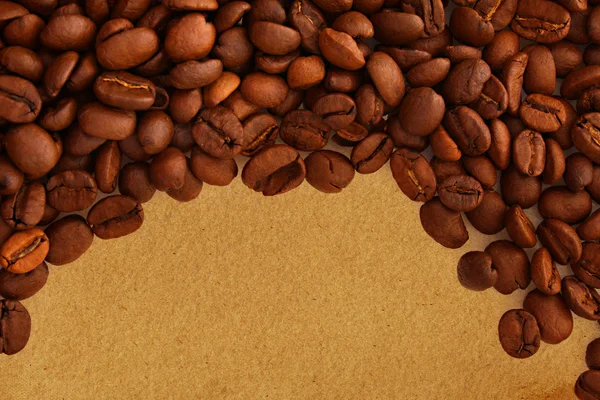 Coffee beans on old paper background — Stock Photo, Image