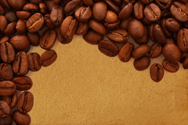 Kaffebönor på gamla papper bakgrund — Stockfoto