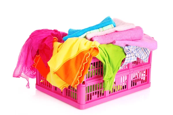 Bright clothes in a laundry basket on white background — Stock Photo, Image