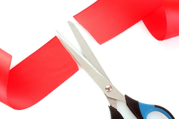 Red ribbon with scissors isolated on white — Stock Photo, Image