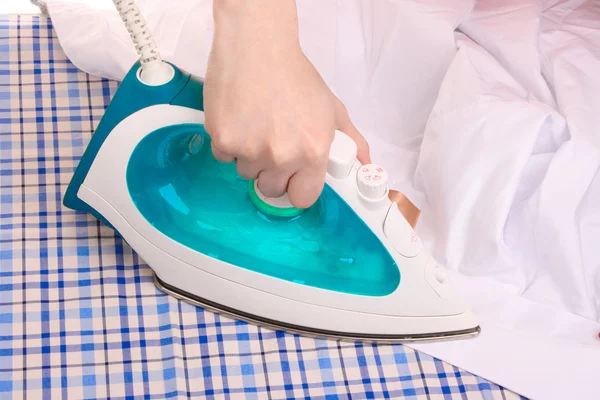 Woman hand ironing a shirt — Stock Photo, Image