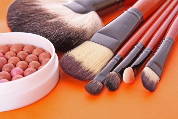 stock image Cosmetic brushes on the orange background