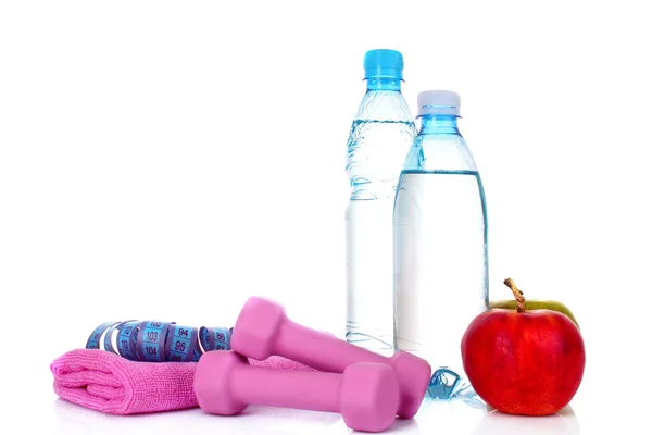 Blue bottle of water, apple and exercise equipment isolated agai — Stock Photo, Image